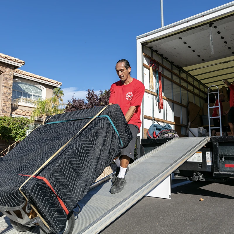 Mover loading furniture onto truck ramp