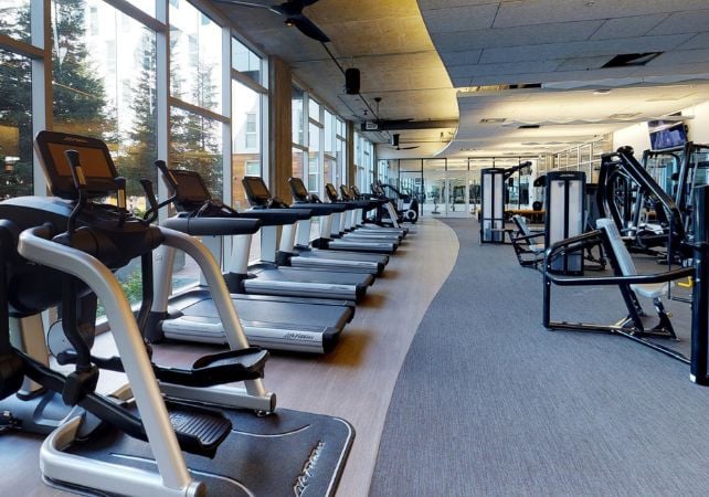 Modern gym with various exercise equipment.