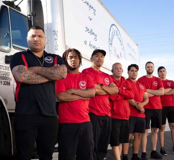 Team of movers standing by a truck.