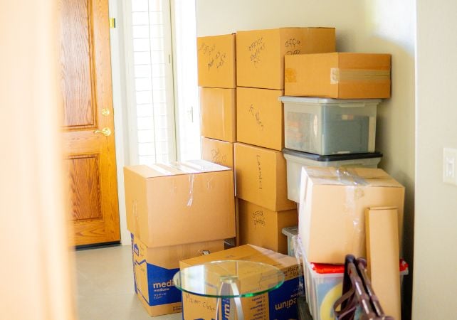 Stacked moving boxes in entryway.